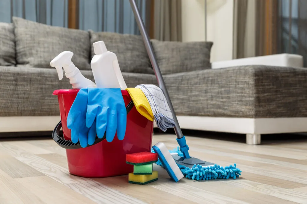 A Bucket Of Cleaning Supplies On The Floor